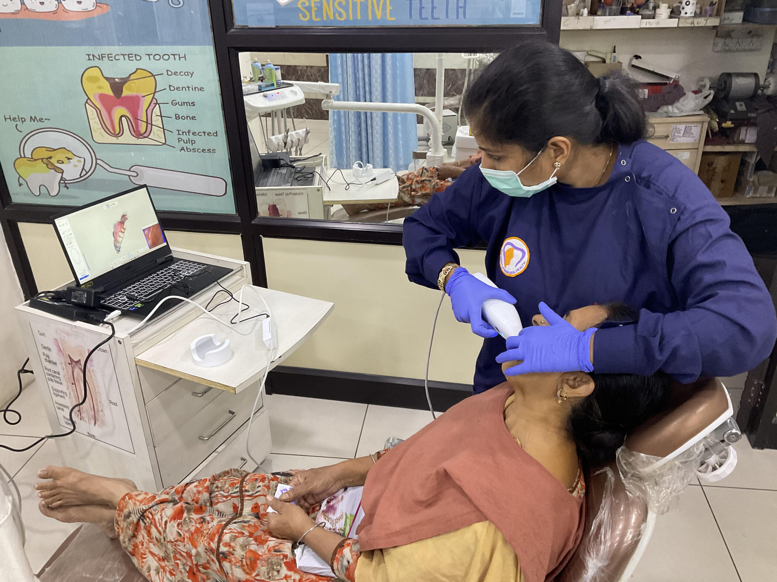 https://dramuljain.com/wp-content/uploads/2023/11/dentist-examining-woman-teeth-with-dental-scanning-2-scaled.jpeg